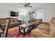 Inviting living room featuring plush sofas, a ceiling fan, and sliding glass doors for natural light at 7505 Pitch Pine Cir # 122, Tampa, FL 33617