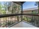 Screened patio with floor tiles, black bars, tree view and neighborhood landscape at 7505 Pitch Pine Cir # 122, Tampa, FL 33617