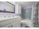 Clean bathroom featuring a vanity, shower-tub combo, and decorative mirror at 7701 Starkey Rd # 443, Seminole, FL 33777