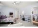 Comfortable bedroom with ceiling fan, carpeted floor, and access to en-suite bathroom at 7701 Starkey Rd # 443, Seminole, FL 33777