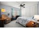 Cozy bedroom with a ceiling fan, carpeted floor, and a relaxing sitting area at 7701 Starkey Rd # 443, Seminole, FL 33777
