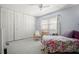 Cozy bedroom featuring a ceiling fan, carpeted floor, and a large closet at 7701 Starkey Rd # 443, Seminole, FL 33777
