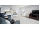 Open-concept living room boasting neutral tones, slider access to enclosed patio, and a pass-through to kitchen at 7701 Starkey Rd # 443, Seminole, FL 33777