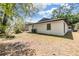 Side view of the house showing the large backyard, a black roof, and freshly painted walls at 8107 N 11Th St, Tampa, FL 33604