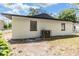 Exterior of the home, featuring an exterior AC unit, freshly painted walls, and windows at 8107 N 11Th St, Tampa, FL 33604