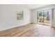 Bright bedroom with modern flooring, new paint and a sliding door leading to the back yard at 8107 N 11Th St, Tampa, FL 33604