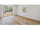 Bright bedroom with modern flooring, new paint and a sliding door leading to the back yard at 8107 N 11Th St, Tampa, FL 33604
