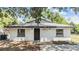 Charming single-story home featuring updated paint, landscaping and exterior lighting at 8107 N 11Th St, Tampa, FL 33604
