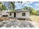 Updated home with new landscaping, gray roof and painted driveway at 8107 N 11Th St, Tampa, FL 33604