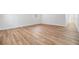 Living room showcasing light wood flooring and bright white walls at 8107 N 11Th St, Tampa, FL 33604