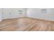 Light and airy living room with white walls and wood-look flooring at 8107 N 11Th St, Tampa, FL 33604