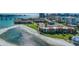 Aerial view showcasing condos on a waterfront property with bridge access and beautiful beach at 865 S Gulfview Blvd # 308, Clearwater, FL 33767