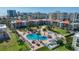 Aerial view showcasing a pool, well-maintained landscaping, and multiple condos at 865 S Gulfview Blvd # 308, Clearwater, FL 33767