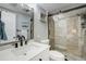 Bright bathroom with a glass enclosed tile shower, white vanity, and black hardware at 865 S Gulfview Blvd # 308, Clearwater, FL 33767