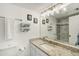Bathroom featuring a granite vanity and tiled shower with glass doors at 865 S Gulfview Blvd # 308, Clearwater, FL 33767