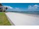 Scenic beach view of a calm inlet and city skyline beyond white sandy beach at 865 S Gulfview Blvd # 308, Clearwater, FL 33767