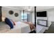 Comfortable bedroom with large bed, TV, ceiling fan, and water view access at 865 S Gulfview Blvd # 308, Clearwater, FL 33767