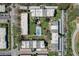 Aerial view of the Cordova Greens complex featuring lush landscaping, a swimming pool, and well-maintained buildings at 8703 Bardmoor Blvd # 305, Seminole, FL 33777
