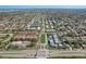 Extensive aerial view showcasing community near a wide road with lush greenery, neighborhood, and crosswalk at 8703 Bardmoor Blvd # 305, Seminole, FL 33777