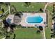 Aerial view showcasing the pool, hot tub, and lush green landscaping of the community at 8703 Bardmoor Blvd # 305, Seminole, FL 33777