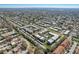 Aerial view outlines the complex within a serene, green neighborhood with lush landscaping and a swimming pool at 8703 Bardmoor Blvd # 305, Seminole, FL 33777