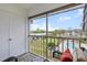 Relaxing balcony with seating showcasing a serene view of community landscaping and pool at 8703 Bardmoor Blvd # 305, Seminole, FL 33777