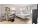 Cozy bedroom with a white metal bed frame and a comfortable sitting area at 8703 Bardmoor Blvd # 305, Seminole, FL 33777