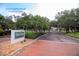 The Bayou Club entrance sign surrounded by lush landscaping and a brick entrance at 8703 Bardmoor Blvd # 305, Seminole, FL 33777