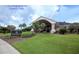 Inviting entrance of the Bardmoor Golf & Tennis Club, featuring lush landscaping and elegant architecture at 8703 Bardmoor Blvd # 305, Seminole, FL 33777