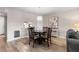 Dining room with seating for four and an open view to the kitchen at 8703 Bardmoor Blvd # 305, Seminole, FL 33777