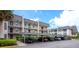 Exterior of the building with covered parking for residents and a neatly maintained landscape at 8703 Bardmoor Blvd # 305, Seminole, FL 33777