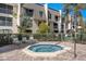 Community hot tub area with comfortable lounge chairs for relaxation and enjoyment at 8703 Bardmoor Blvd # 305, Seminole, FL 33777
