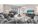 Cozy living room with modern furniture, light hardwood flooring, and a view into the bedroom at 8703 Bardmoor Blvd # 305, Seminole, FL 33777