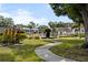 Manicured landscaping provides access to a sparkling community swimming pool with lounge area at 8703 Bardmoor Blvd # 305, Seminole, FL 33777