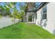 Spacious backyard featuring a covered patio and white vinyl fencing at 8906 N Otis Ave, Tampa, FL 33604