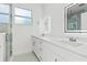 Modern bathroom with double sinks, white cabinets, and a walk-in shower at 8906 N Otis Ave, Tampa, FL 33604