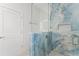 Modern bathroom with blue marble tiling, glass shower, and a sleek, contemporary design at 8906 N Otis Ave, Tampa, FL 33604