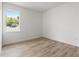Bright bedroom with a window offering natural light and scenic views, complemented by wood floors at 8906 N Otis Ave, Tampa, FL 33604