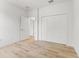 Bright bedroom with wood floors and a closet with folding doors providing ample storage solutions at 8906 N Otis Ave, Tampa, FL 33604