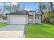 Charming single-Gathering home with a well-manicured lawn and a paved driveway at 8906 N Otis Ave, Tampa, FL 33604