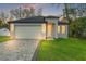Charming single-story home with modern curb appeal, garage, and paved driveway at 8906 N Otis Ave, Tampa, FL 33604