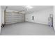 Spacious garage with epoxy floors, ample space, and water heater at 8906 N Otis Ave, Tampa, FL 33604