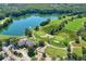 Scenic aerial view of the community golf course and lake surrounded by lush trees at 9503 W. Park Village Dr, Tampa, FL 33626