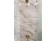 Close up of marble tiled shower with gold shower head at 9503 W. Park Village Dr, Tampa, FL 33626