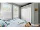 Bedroom showcasing white shuttered windows, gray walls, and a double-door closet at 9503 W. Park Village Dr, Tampa, FL 33626
