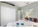 Bedroom showcasing closet, door, and writing desk at 9503 W. Park Village Dr, Tampa, FL 33626