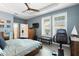 Bedroom with exercise equipment, windows, and a ceiling fan at 9503 W. Park Village Dr, Tampa, FL 33626