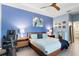 Primary bedroom with blue walls, modern decor, and exercise equipment at 9503 W. Park Village Dr, Tampa, FL 33626