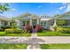 Charming craftsman-style home featuring a lush landscaped front yard and inviting covered porch at 9503 W. Park Village Dr, Tampa, FL 33626