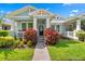 Inviting home exterior featuring a well-manicured lawn, colorful foliage, and a welcoming front entrance at 9503 W. Park Village Dr, Tampa, FL 33626